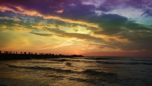 A stunning capture of the suns descent during winter in Kanyakumari, displaying a radiant burst of colours across the sky