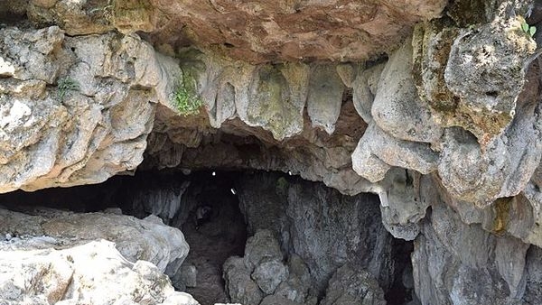Adventurous team of college friends exploring the echoey caves in Meghalaya