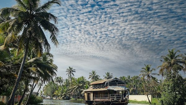 Beautiful houseboat cruising through serene backwaters Beautiful houseboat cruising through serene backwaters