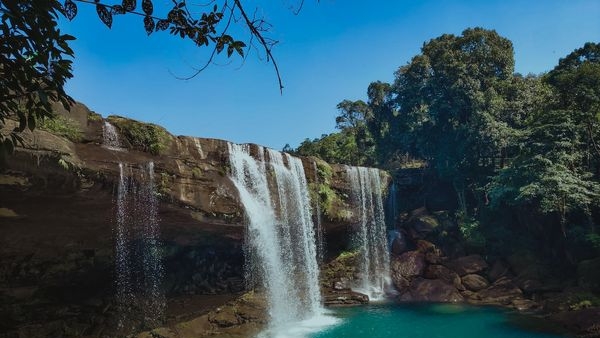 College friends enjoying the placid view of waterfalls in Meghalaya