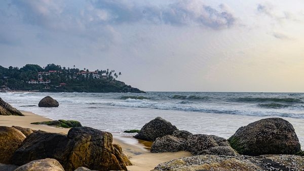Honeymoon couple having a pleasant walk on the beach, watching the sunset at Kovalam. Honeymoon couple having a pleasant walk on the beach, watching the sunset at Kovalam.