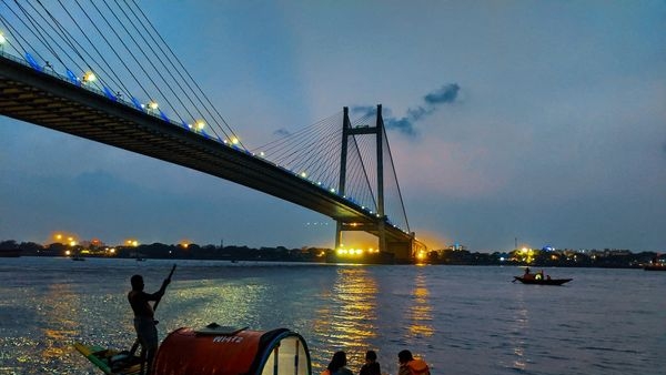 Image depicts the calming view of boat ride in the Hooghly River at dusk Image depicts the calming view of boat ride in the Hooghly River at dusk