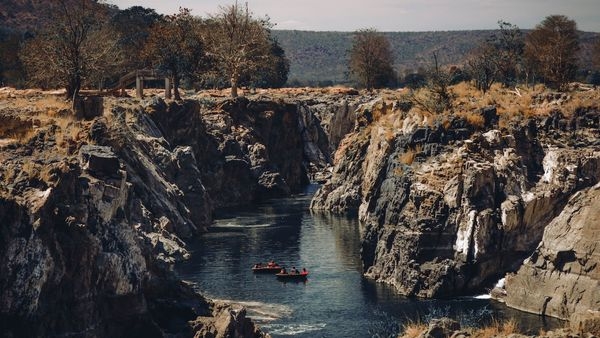 Photogenic landscapes of Cauvery River journey featuring lush forests and waterfalls