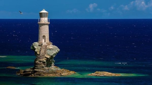 The unique and beautiful Tourlitis Lighthouse amid the crystal clear Aegean waters The unique and beautiful Tourlitis Lighthouse amid the crystal clear Aegean waters