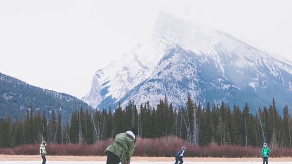 A snowboarder gliding down Canadian slopes