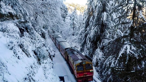 Image alt text: Enchanting winter view from the Kalka-Shimla Toy Train, showcasing the snow-covered hills. Image alt text: Enchanting winter view from the Kalka-Shimla Toy Train, showcasing the snow-covered hills.