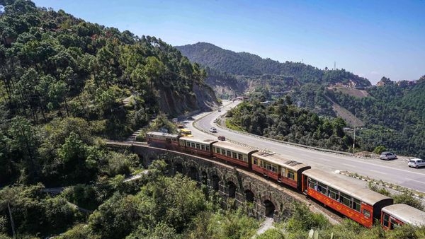 Image alt text: The Iconic Kalka-Shimla Toy Train passing the historic Barog Tunnel amidst mesmerising scenery. Image alt text: The Iconic Kalka-Shimla Toy Train passing the historic Barog Tunnel amidst mesmerising scenery.