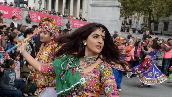 Image shows attendees enjoying spiritual activities like yoga and meditation at the Diwali event