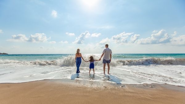 Parents supervising kids while they play on beach